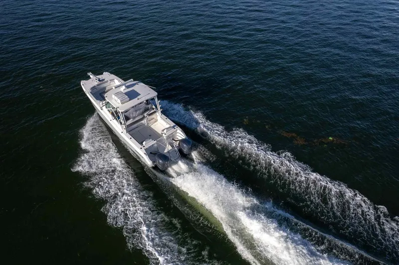  Yacht Photos Pics 2017 World Cat 295 DC cruising on open water, aerial view.