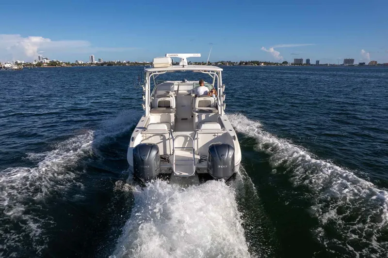  Yacht Photos Pics 2017 World Cat 295 DC cruising on open water, rear view with twin engines.