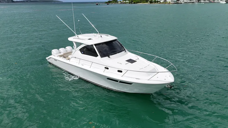  Yacht Photos Pics 2019 Pursuit OS 355 Offshore boat on calm turquoise water.