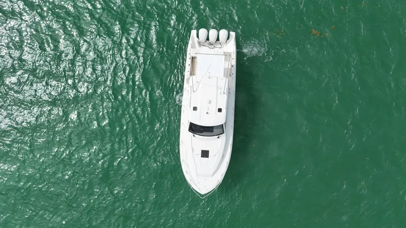  Yacht Photos Pics Aerial view of 2019 Pursuit OS 355 Offshore boat on green water.
