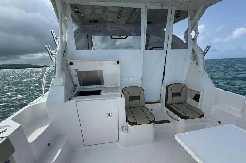  Yacht Photos Pics 2019 Pursuit OS 355 Offshore boat interior with seating and ocean view.