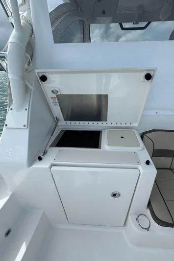  Yacht Photos Pics 2019 Pursuit OS 355 Offshore boat interior with kitchenette and seating area.