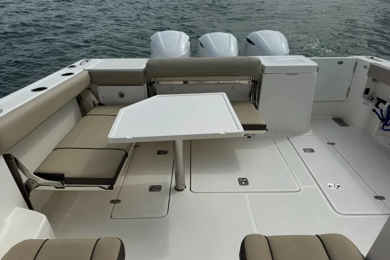  Yacht Photos Pics 2019 Pursuit OS 355 Offshore boat interior with seating and table on the water.