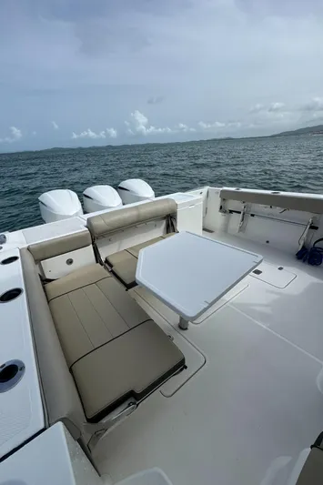  Yacht Photos Pics 2019 Pursuit OS 355 Offshore boat interior with seating and table, ocean view.
