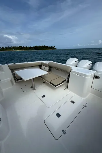  Yacht Photos Pics 2019 Pursuit OS 355 Offshore boat deck with seating, table, and ocean view.