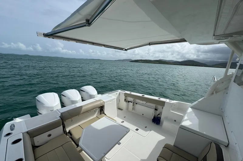  Yacht Photos Pics 2019 Pursuit OS 355 Offshore boat with triple engines, spacious deck, and ocean view.