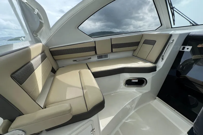  Yacht Photos Pics 2019 Pursuit OS 355 Offshore boat interior with beige seating and modern design.