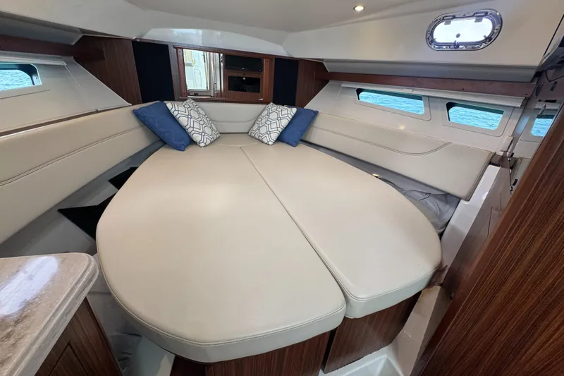  Yacht Photos Pics 2019 Pursuit OS 355 Offshore cabin with cozy bed and decorative pillows.