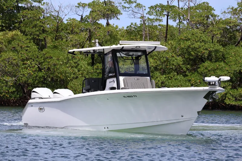  Yacht Photos Pics 2022 Sea Hunt Gamefish 30 Coffin Box boat cruising on a calm waterway.