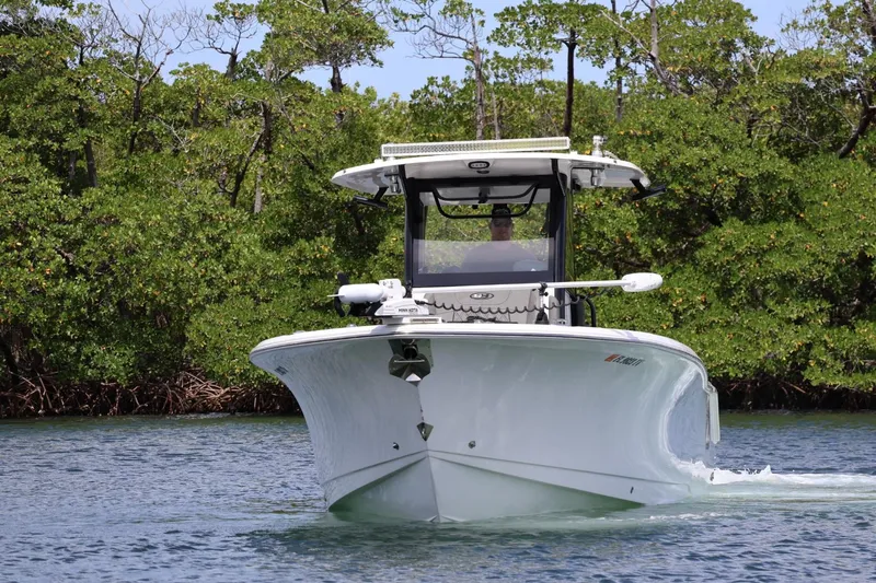  Yacht Photos Pics 2022 Sea Hunt Gamefish 30 Coffin Box boat cruising on a calm waterway.