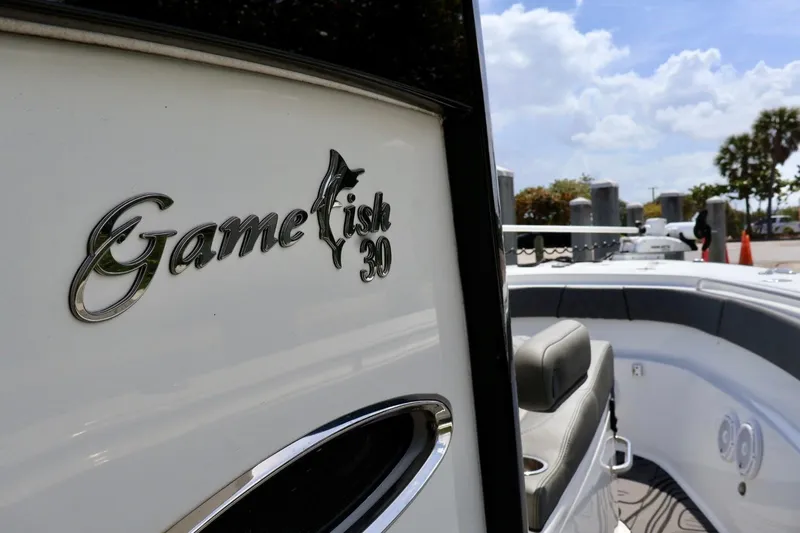  Yacht Photos Pics 2022 Sea Hunt Gamefish 30 Coffin Box boat, sleek design, sunny marina backdrop.