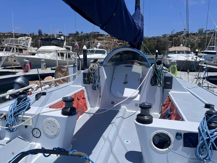 Yippee Kai Yay Yacht Photos Pics Sailboat cockpit of 2009 Class 40 Antrim Design, docked in a marina under clear skies.