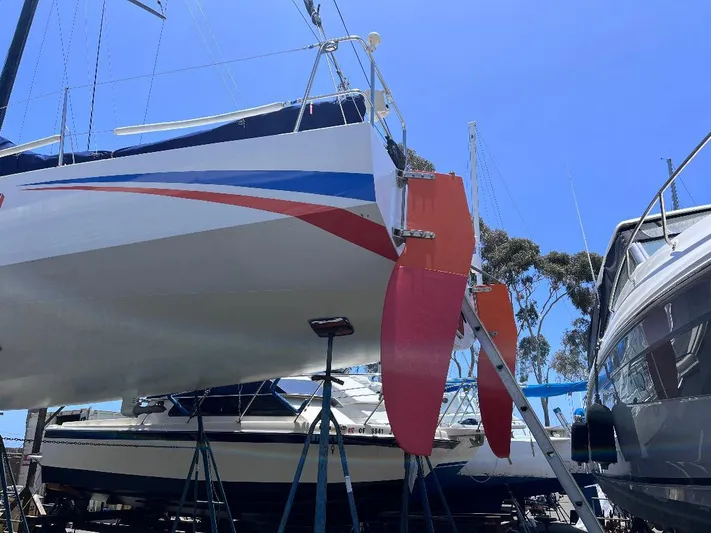 Yippee Kai Yay Yacht Photos Pics Sailboat on stands, Class 40 Antrim Design, 2009, with vibrant red and blue accents.