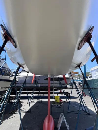 Yippee Kai Yay Yacht Photos Pics Underneath view of a 2009 Class 40 Antrim Design sailboat on stands in a boatyard.