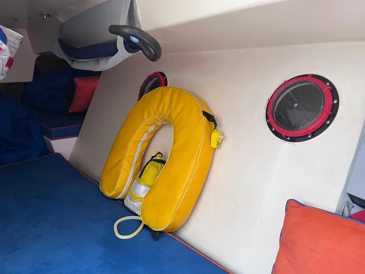 Yippee Kai Yay Yacht Photos Pics Interior of 2009 Class 40 Antrim Design boat with life preserver and colorful cushions.