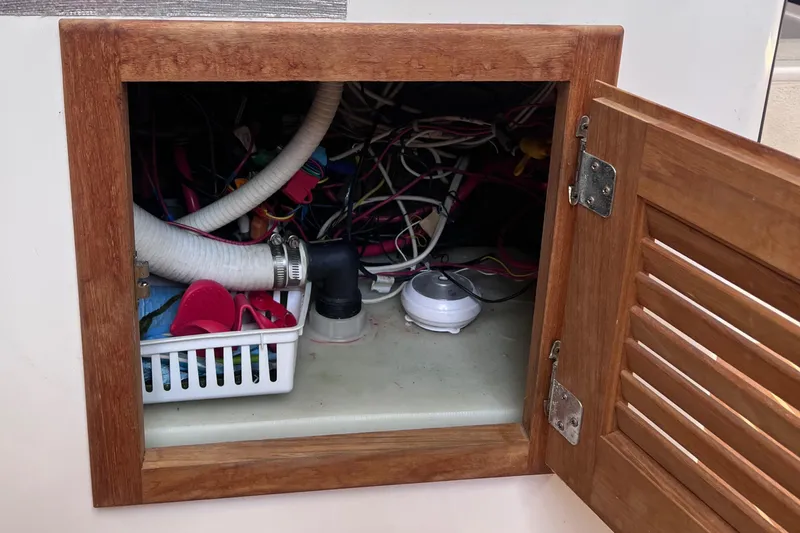 Yippee Kai Yay Yacht Photos Pics Open wooden cabinet revealing boat wiring and storage, Class 40 Antrim Design, 2009.