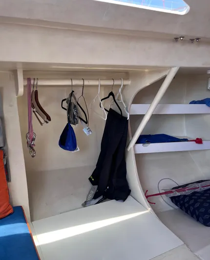 Yippee Kai Yay Yacht Photos Pics Interior of 2009 Class 40 Antrim Design sailboat with hanging clothes and storage shelves.