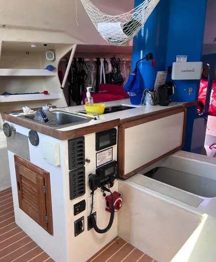 Yippee Kai Yay Yacht Photos Pics Interior of 2009 Class 40 Antrim Design yacht with navigation equipment and compact kitchen area.