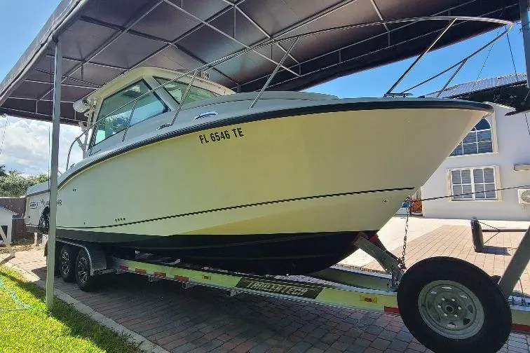 The Snapper Slapper Yacht Photos Pics 2014 Boston Whaler 315 Conquest Pilothouse on trailer under canopy.