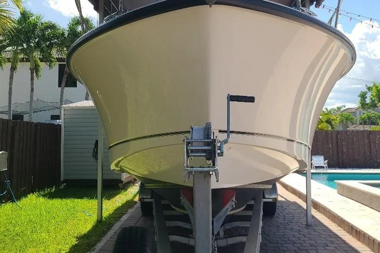 The Snapper Slapper Yacht Photos Pics 2014 Boston Whaler 315 Conquest Pilothouse on trailer near poolside, sunny day.