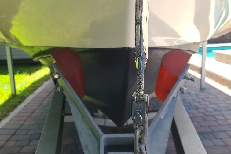 The Snapper Slapper Yacht Photos Pics 2014 Boston Whaler 315 Conquest Pilothouse on trailer, close-up view of hull and chain.