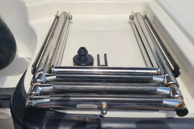 The Snapper Slapper Yacht Photos Pics Folded stainless steel ladder on a 2014 Boston Whaler 315 Conquest Pilothouse boat.