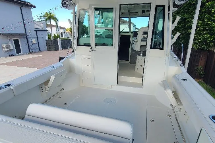 The Snapper Slapper Yacht Photos Pics 2014 Boston Whaler 315 Conquest Pilothouse boat interior, featuring spacious deck and seating.