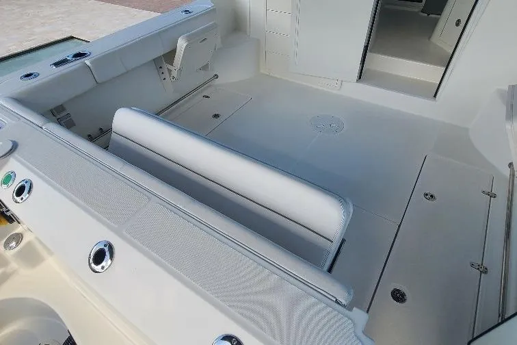 The Snapper Slapper Yacht Photos Pics 2014 Boston Whaler 315 Conquest Pilothouse interior with seating and storage compartments.