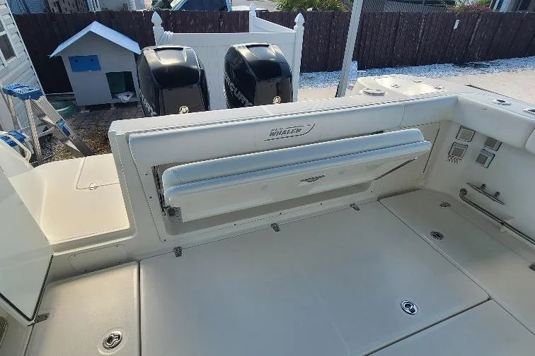 The Snapper Slapper Yacht Photos Pics 2014 Boston Whaler 315 Conquest Pilothouse deck with dual engines and seating.