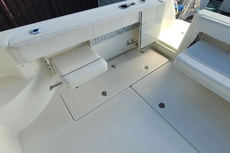 The Snapper Slapper Yacht Photos Pics 2014 Boston Whaler 315 Conquest Pilothouse interior with seating and storage compartments.