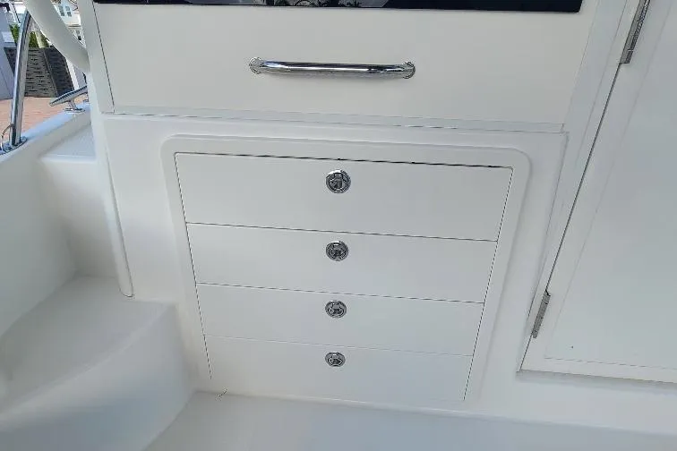 The Snapper Slapper Yacht Photos Pics 2014 Boston Whaler 315 Conquest Pilothouse interior storage drawers and cabinetry.