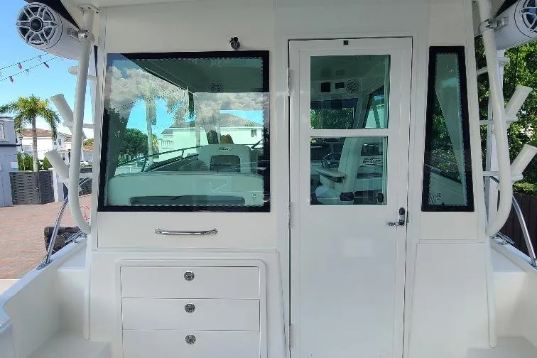 The Snapper Slapper Yacht Photos Pics 2014 Boston Whaler 315 Conquest Pilothouse, rear view with windows and door.