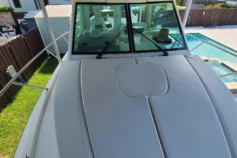 The Snapper Slapper Yacht Photos Pics 2014 Boston Whaler 315 Conquest Pilothouse boat docked near a pool.