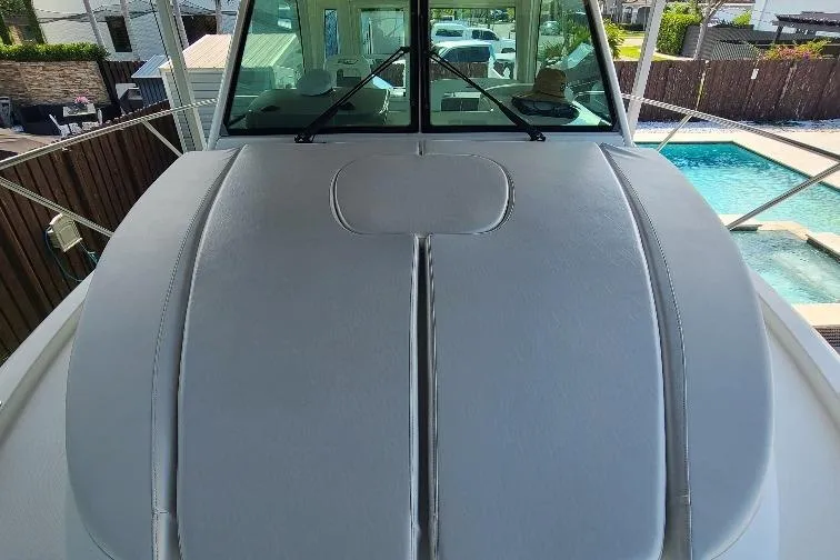 The Snapper Slapper Yacht Photos Pics 2014 Boston Whaler 315 Conquest Pilothouse boat with sleek deck design near a pool.