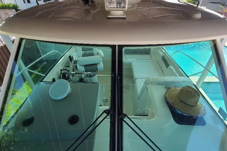 The Snapper Slapper Yacht Photos Pics 2014 Boston Whaler 315 Conquest Pilothouse interior with helm and seating area.