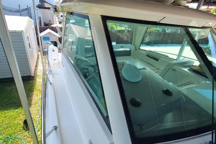 The Snapper Slapper Yacht Photos Pics 2014 Boston Whaler 315 Conquest Pilothouse, side view, docked near garden sheds.