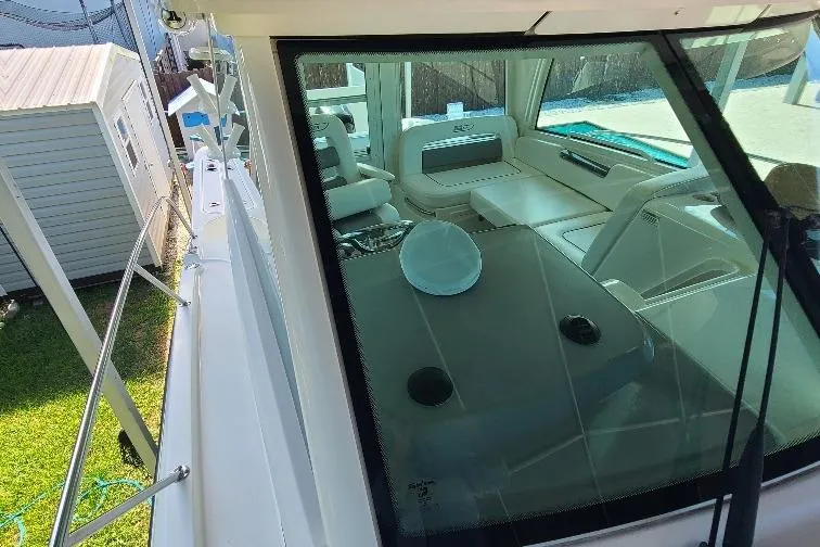 The Snapper Slapper Yacht Photos Pics 2014 Boston Whaler 315 Conquest Pilothouse, interior view through windshield, docked outdoors.