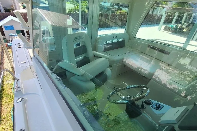 The Snapper Slapper Yacht Photos Pics 2014 Boston Whaler 315 Conquest Pilothouse interior with helm and seating area.