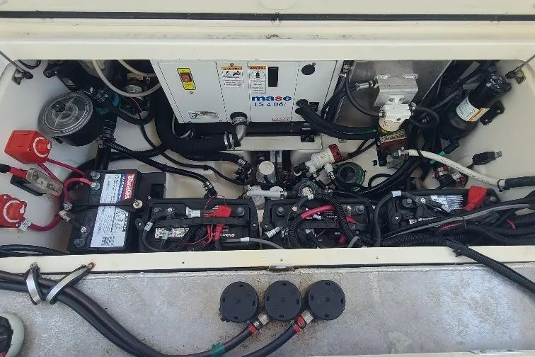 The Snapper Slapper Yacht Photos Pics Engine compartment of a 2014 Boston Whaler 315 Conquest Pilothouse with batteries and wiring.