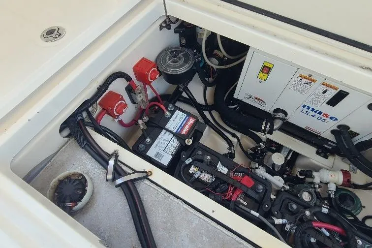 The Snapper Slapper Yacht Photos Pics Engine compartment of a 2014 Boston Whaler 315 Conquest Pilothouse, showcasing batteries and wiring.