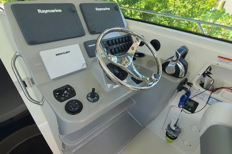 The Snapper Slapper Yacht Photos Pics 2014 Boston Whaler 315 Conquest Pilothouse helm with Raymarine electronics and Mercury controls.