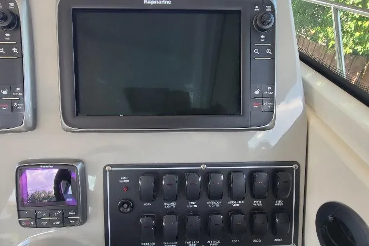 The Snapper Slapper Yacht Photos Pics Control panel of 2014 Boston Whaler 315 Conquest Pilothouse with Raymarine display.