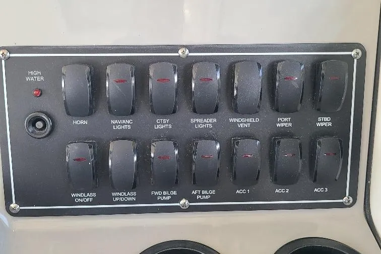 The Snapper Slapper Yacht Photos Pics Control panel of a 2014 Boston Whaler 315 Conquest Pilothouse with labeled switches.
