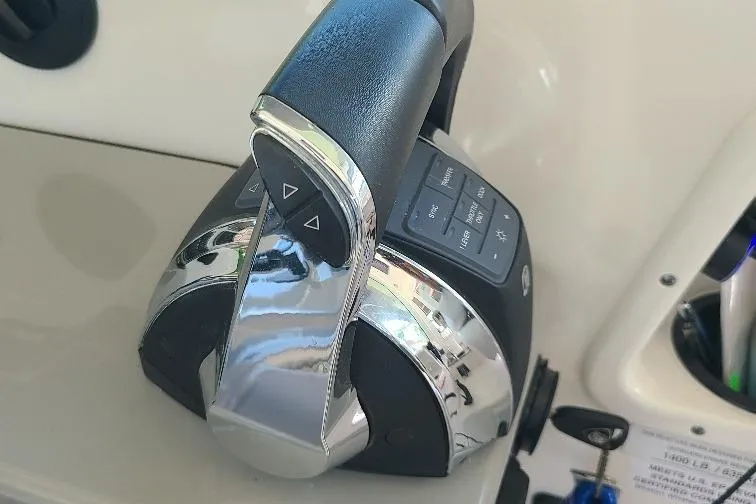 The Snapper Slapper Yacht Photos Pics Throttle control of 2014 Boston Whaler 315 Conquest Pilothouse boat, featuring chrome and black design.