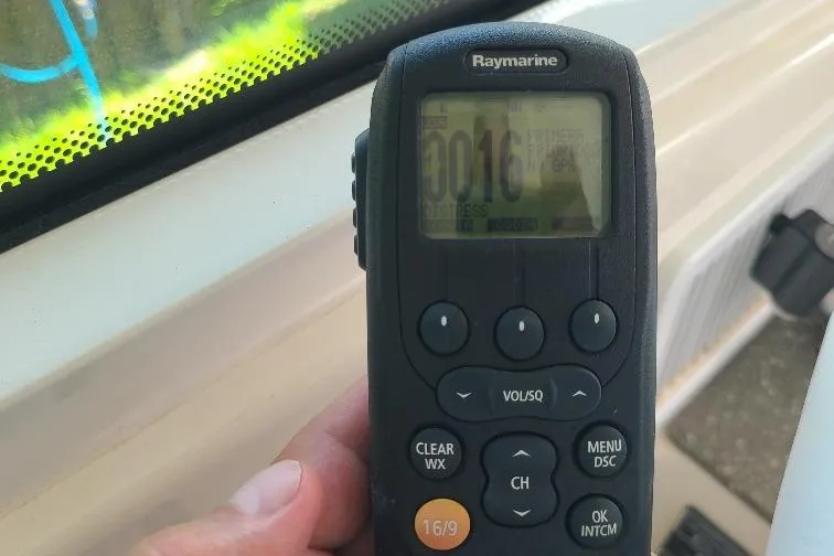 The Snapper Slapper Yacht Photos Pics Hand holding Raymarine marine radio on 2014 Boston Whaler 315 Conquest Pilothouse.