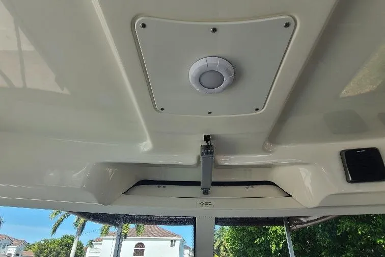 The Snapper Slapper Yacht Photos Pics Ceiling view of 2014 Boston Whaler 315 Conquest Pilothouse with light fixture.