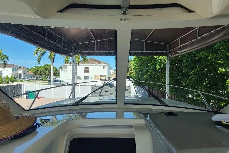The Snapper Slapper Yacht Photos Pics 2014 Boston Whaler 315 Conquest Pilothouse interior view with outdoor scenery.