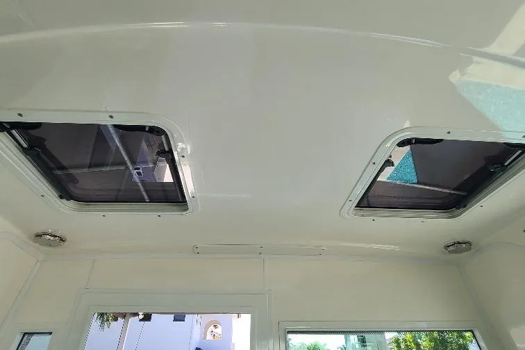 The Snapper Slapper Yacht Photos Pics Ceiling view of 2014 Boston Whaler 315 Conquest Pilothouse with dual hatches.