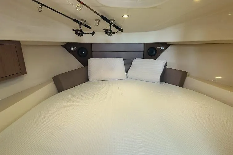The Snapper Slapper Yacht Photos Pics Interior cabin of 2014 Boston Whaler 315 Conquest Pilothouse with cozy bedding.