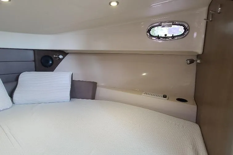 The Snapper Slapper Yacht Photos Pics 2014 Boston Whaler 315 Conquest Pilothouse cabin interior with bed and porthole window.